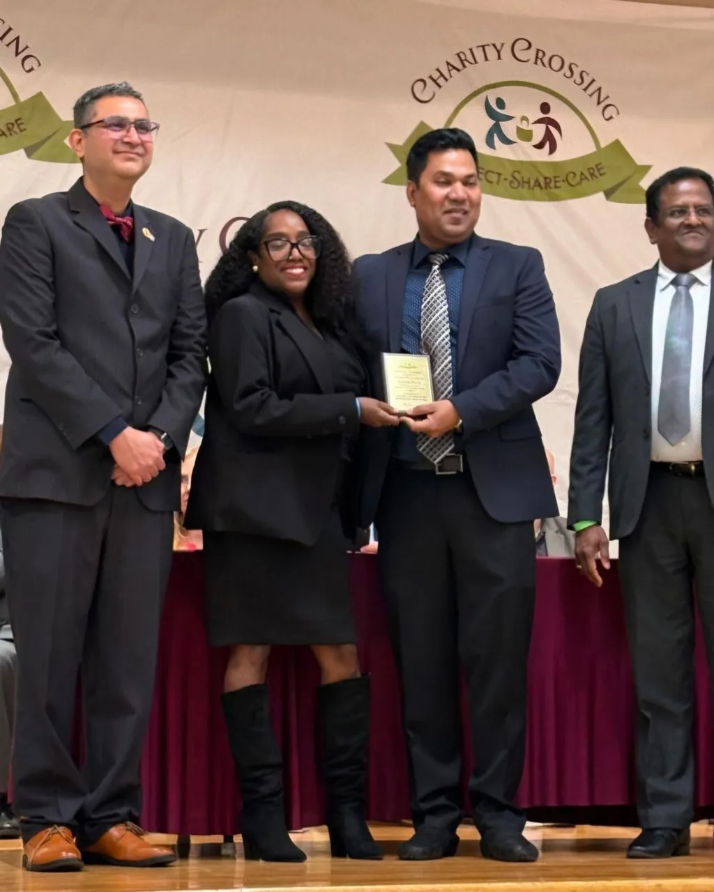 Awards ceremony on stage with banner backdrop